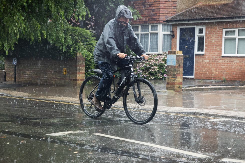 Man cycling through the rain