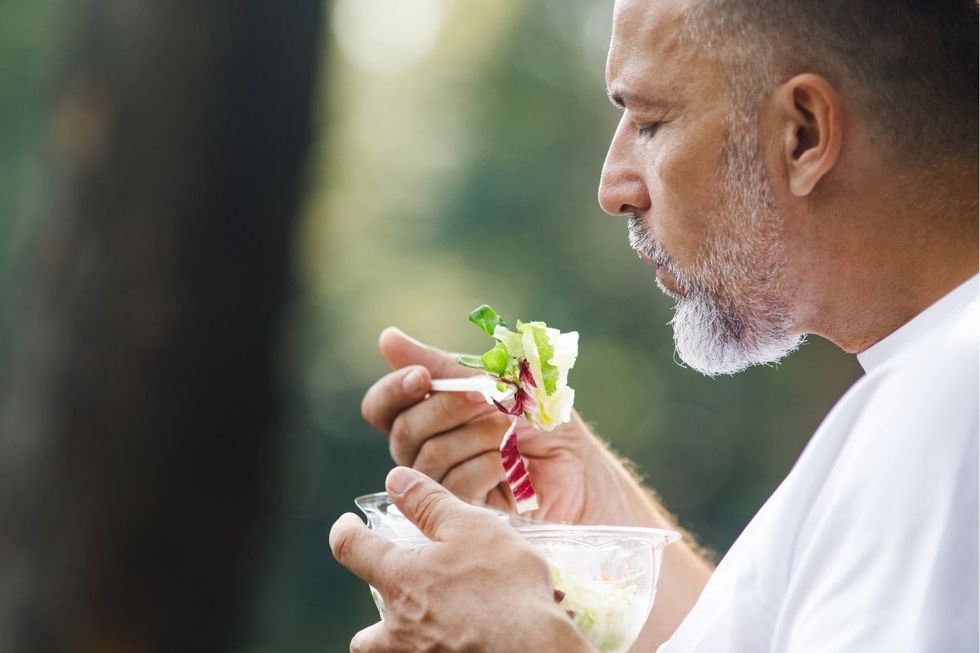 MAN EATING SALAD