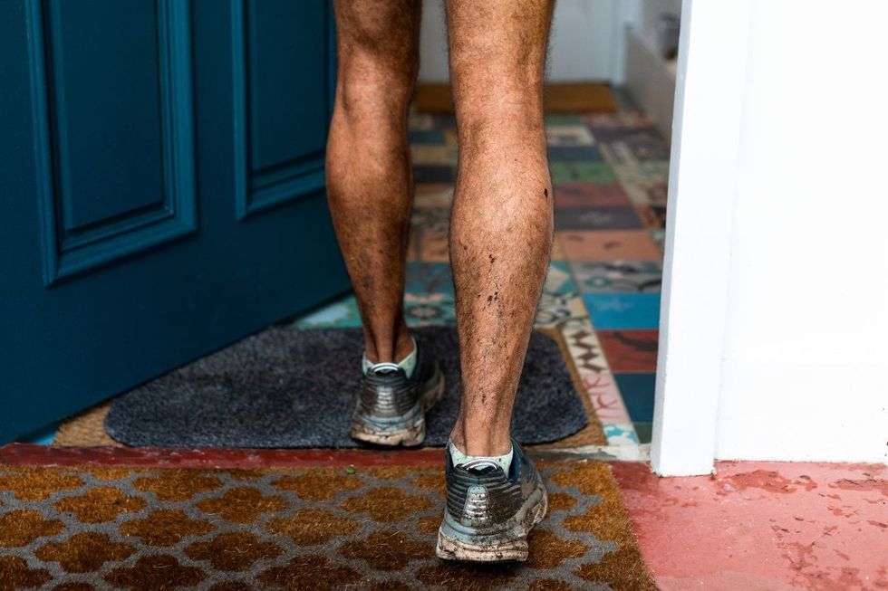 MAN ENTERING HOME WITH MUDDY SHOES