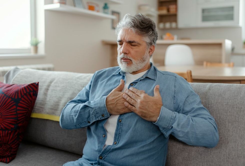 MAN EXPERIENCING CHEST PAIN