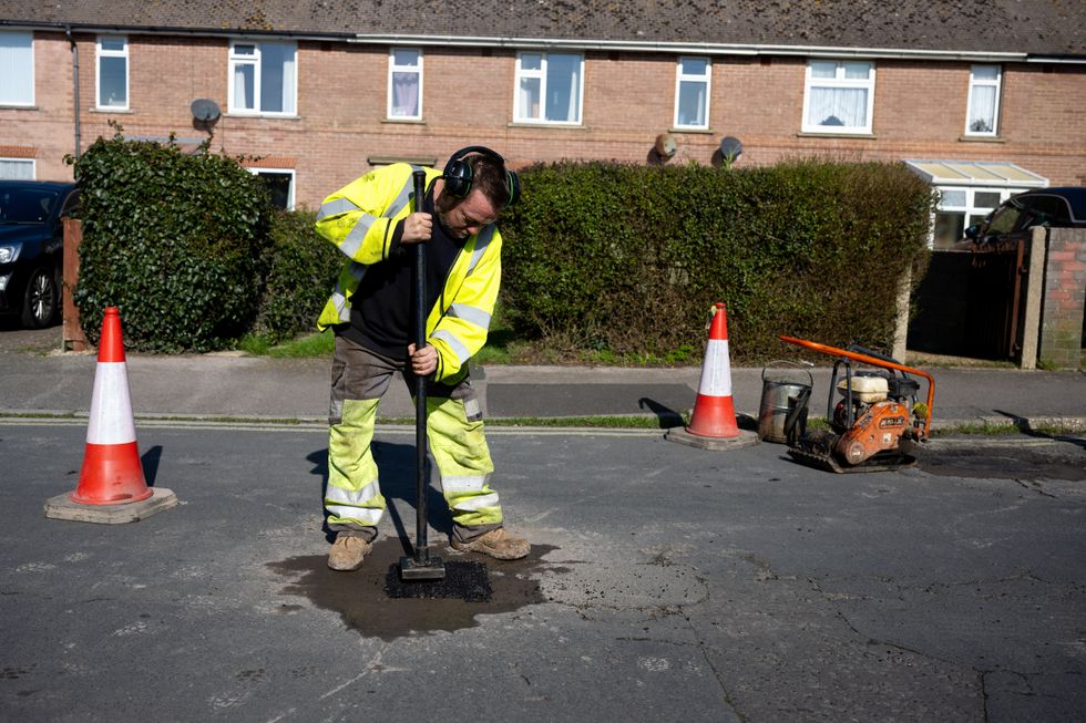Man filling pothole