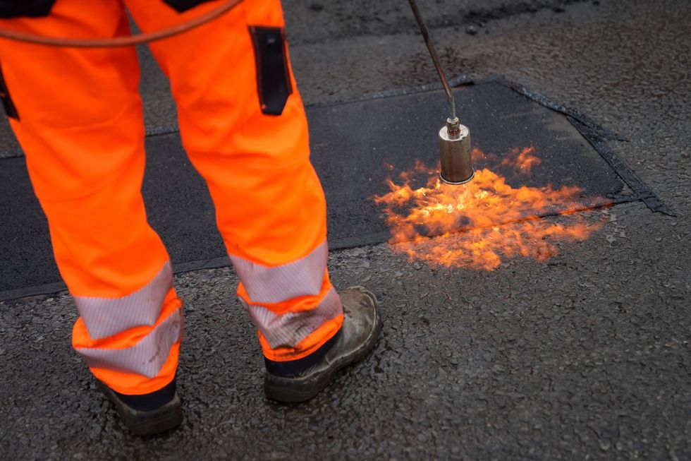 Man fixing pothole