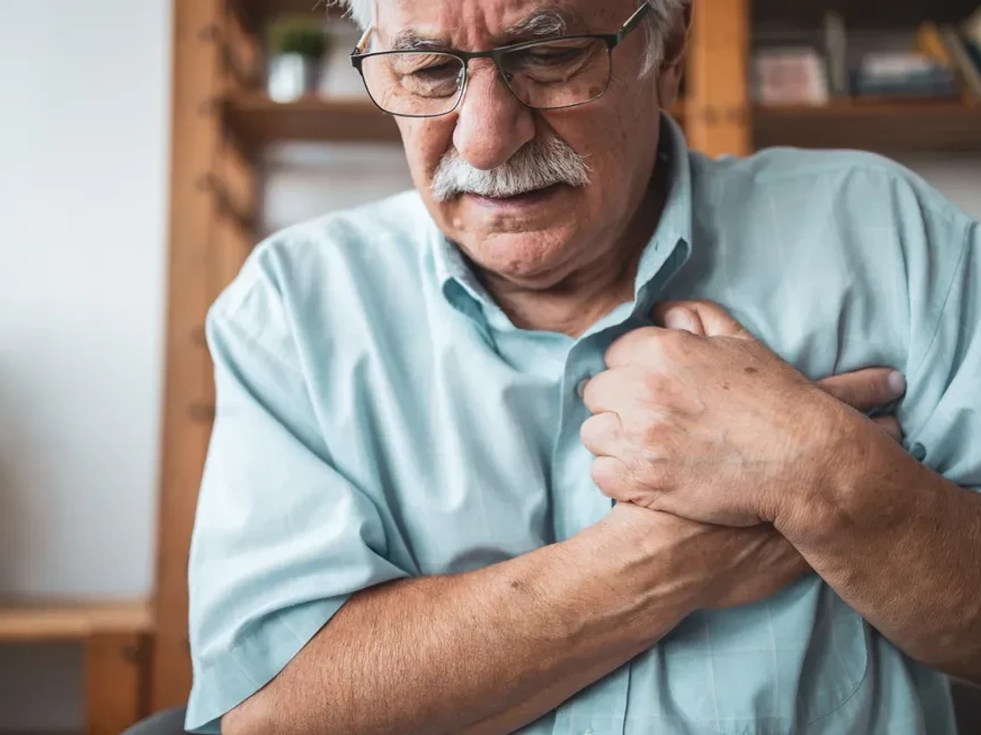 Man gripping his chest