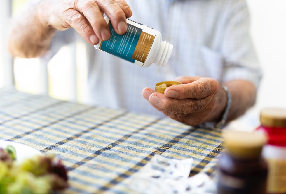 Man handling a bottle of supplements