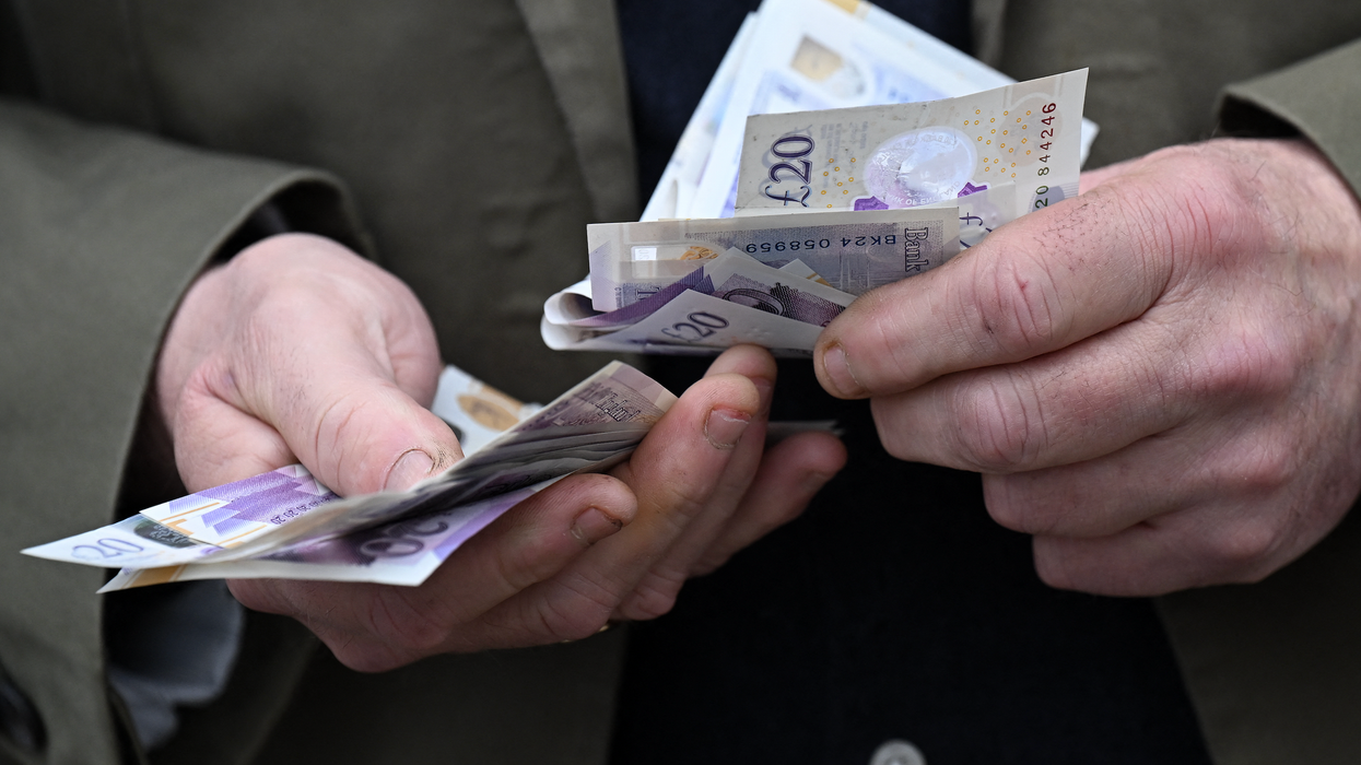 Man handling twenty pound notes
