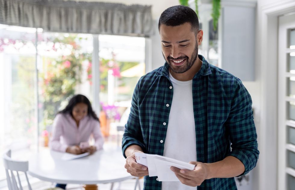 Man happy looking at letters