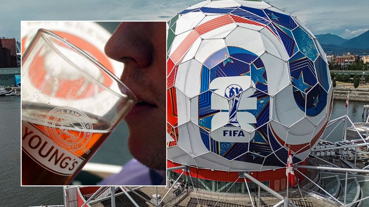 Man having pint and World Cup stadium