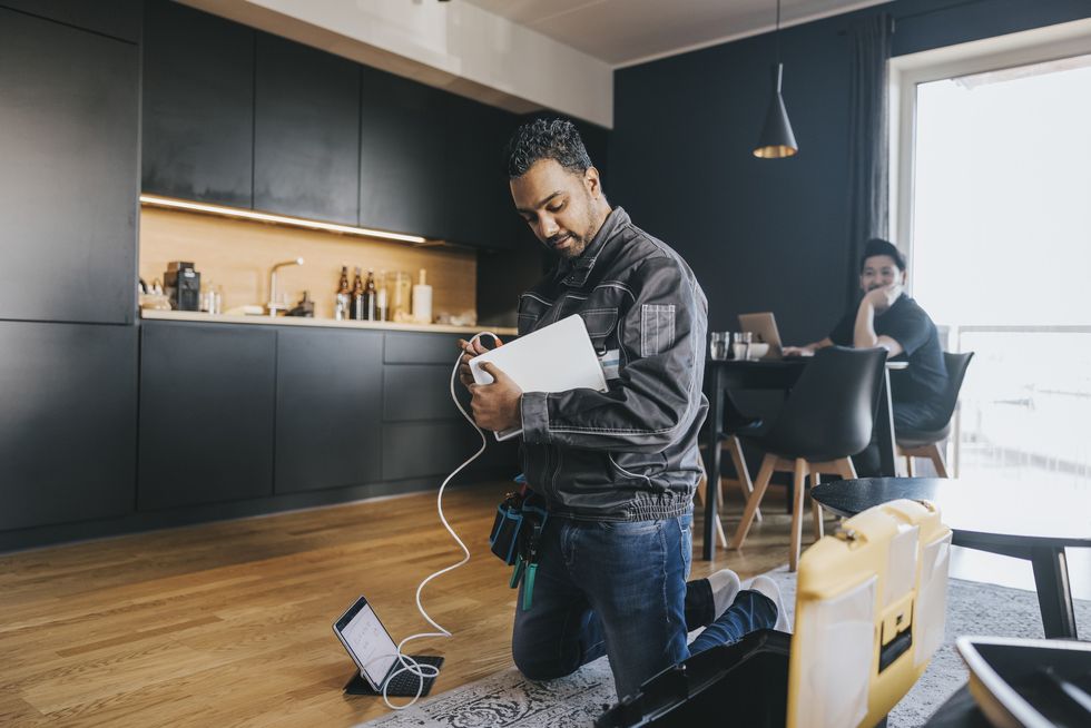 man helps set-up a new broadband connection for a customer