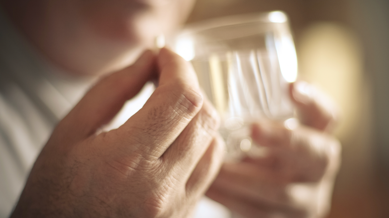 Man holding a supplement