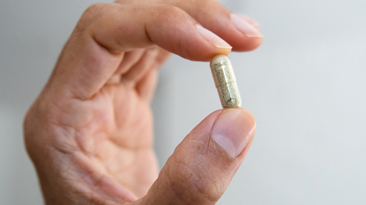 Man holding a supplement