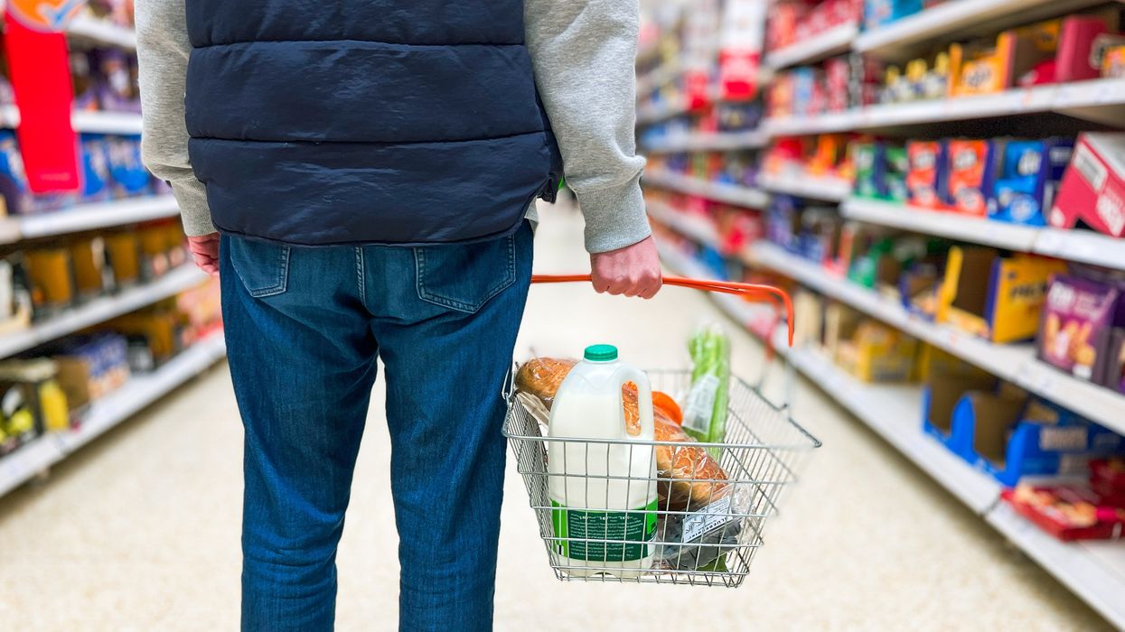 Man holding basket in supermarket