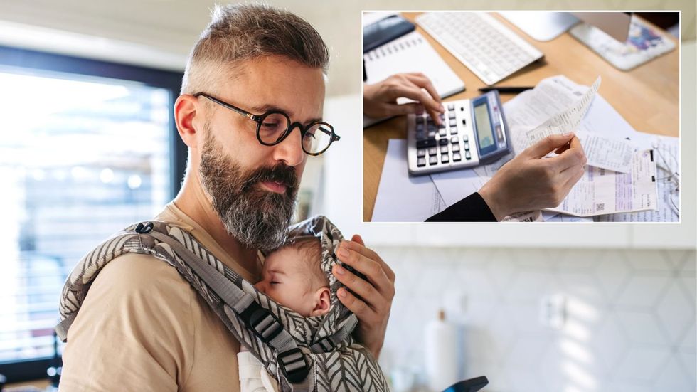 Man holding child worried about taxes