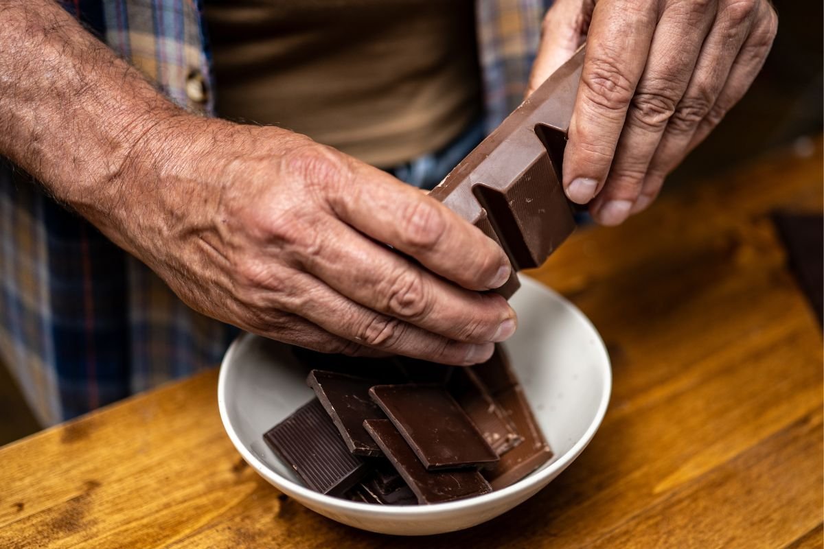 MAN HOLDING DARK CHOCOLATE