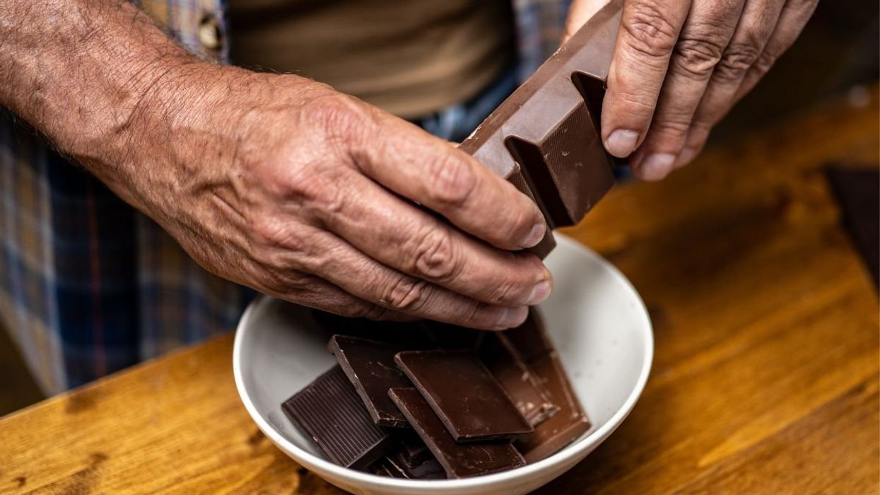 MAN HOLDING DARK CHOCOLATE