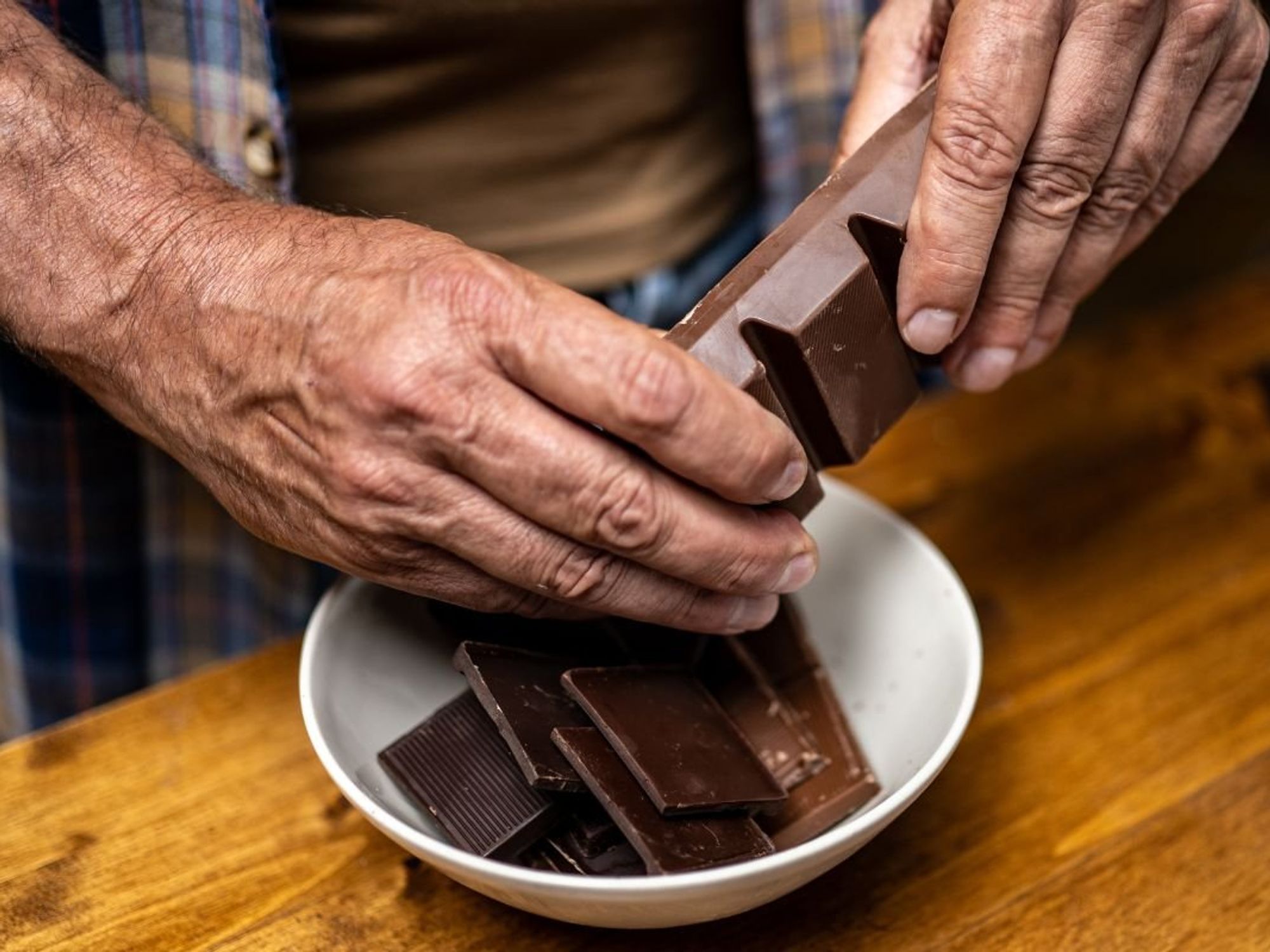 MAN HOLDING DARK CHOCOLATE
