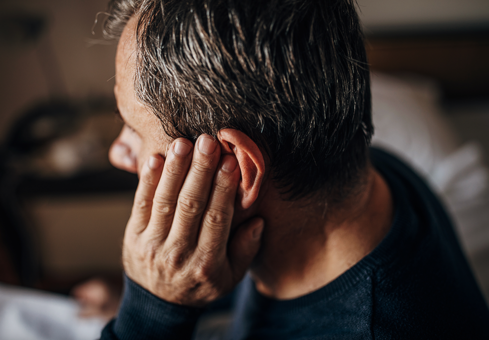 Man holding his ear