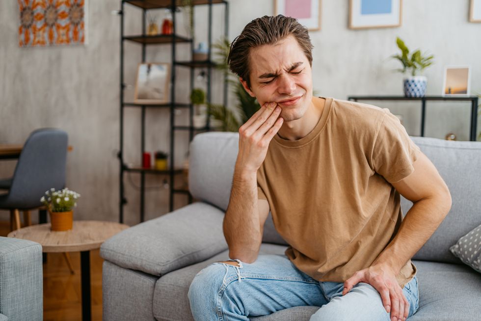 Man holding his face in pain