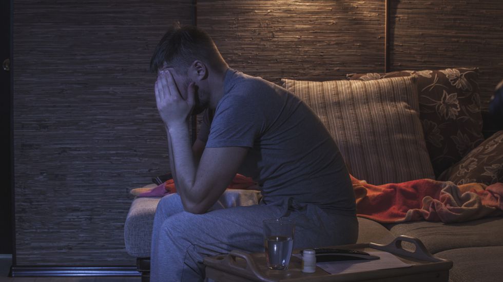 Man holding his face