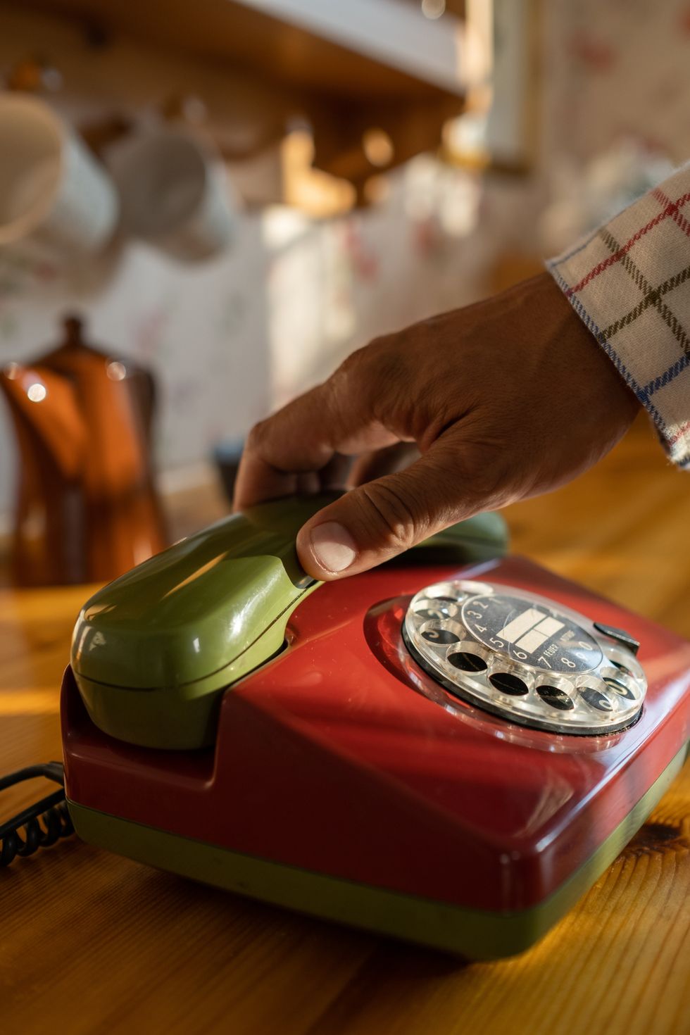 Man holding landline phone