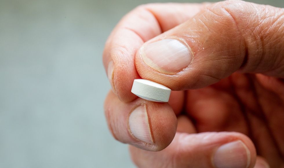 man holding pill