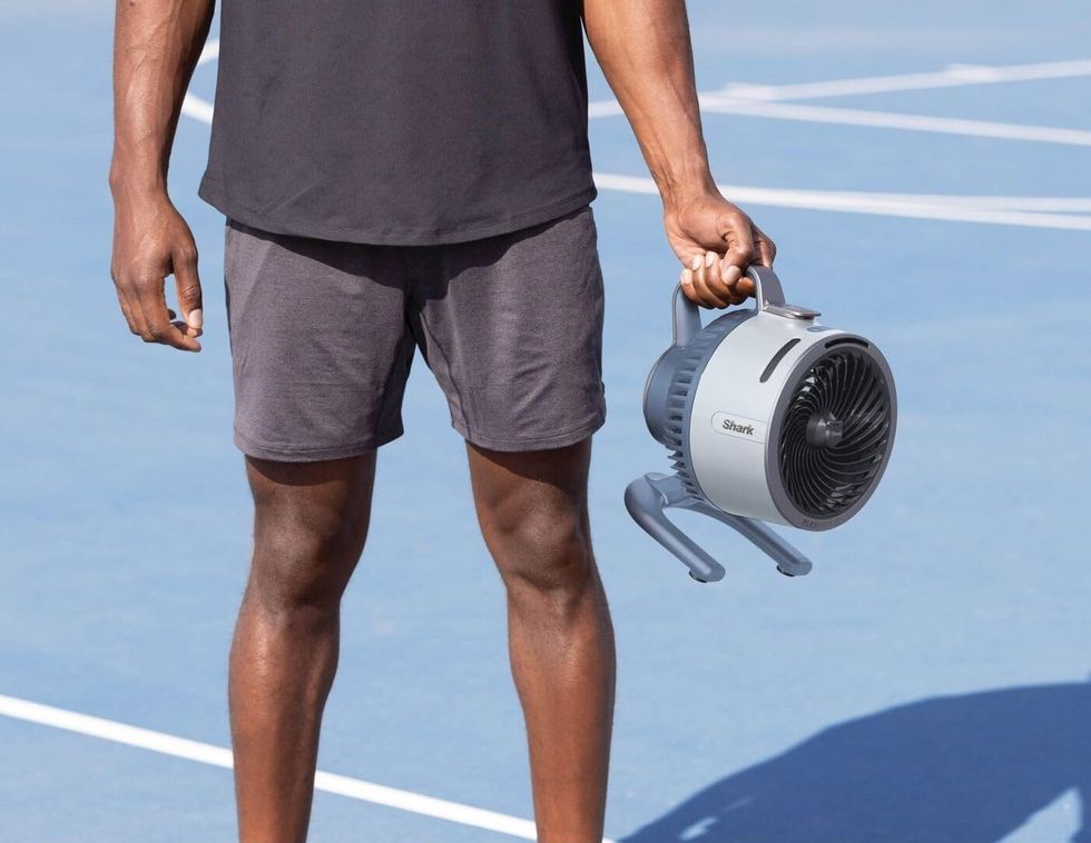 Man holding the Shark FlexBreeze HydroGo cordless fan