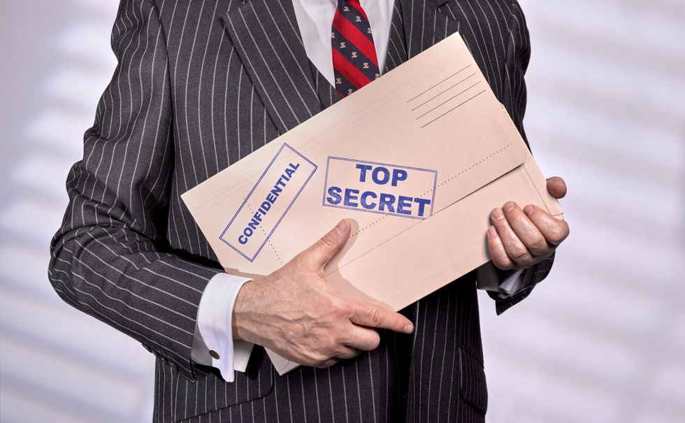 Man holding top secret file