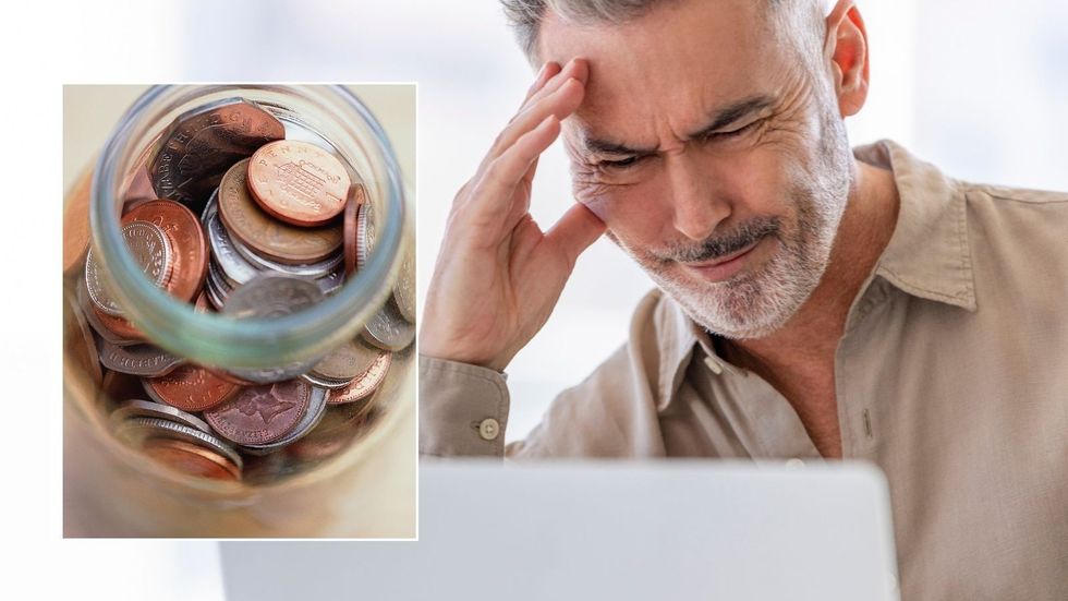 Man looking annoyed at computer and pennies