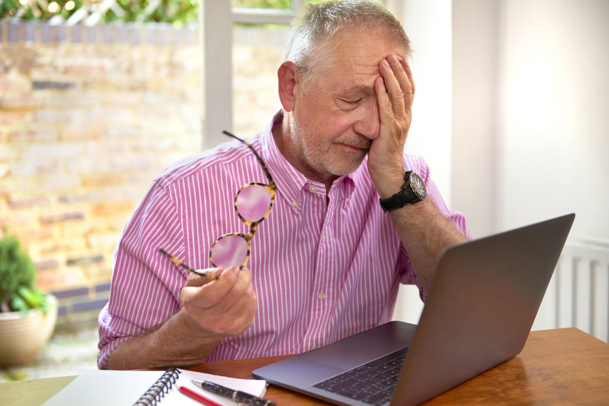 Man looking annoyed at laptop