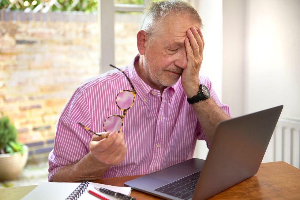 Man looking annoyed at laptop