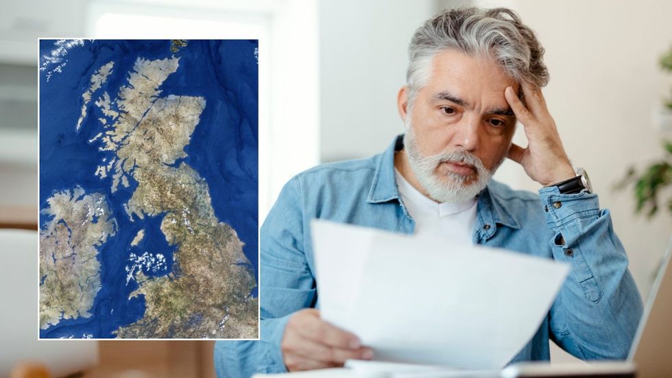 Man looking at bill and UK map