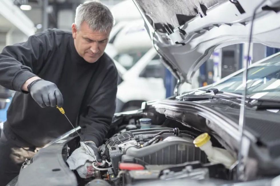 Man looking at car engine