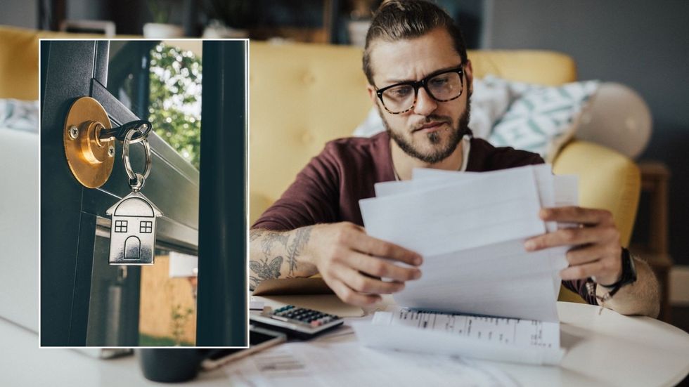 Man looking at form and house keys