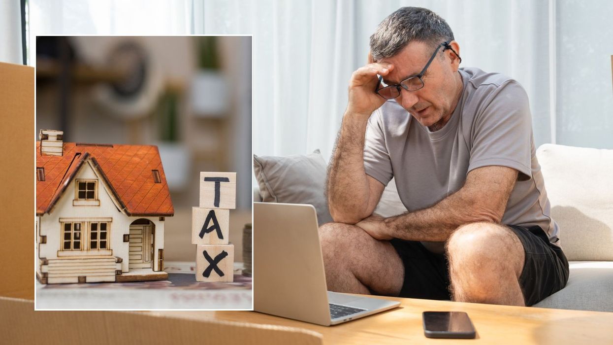 Man looking at laptop and tax sign