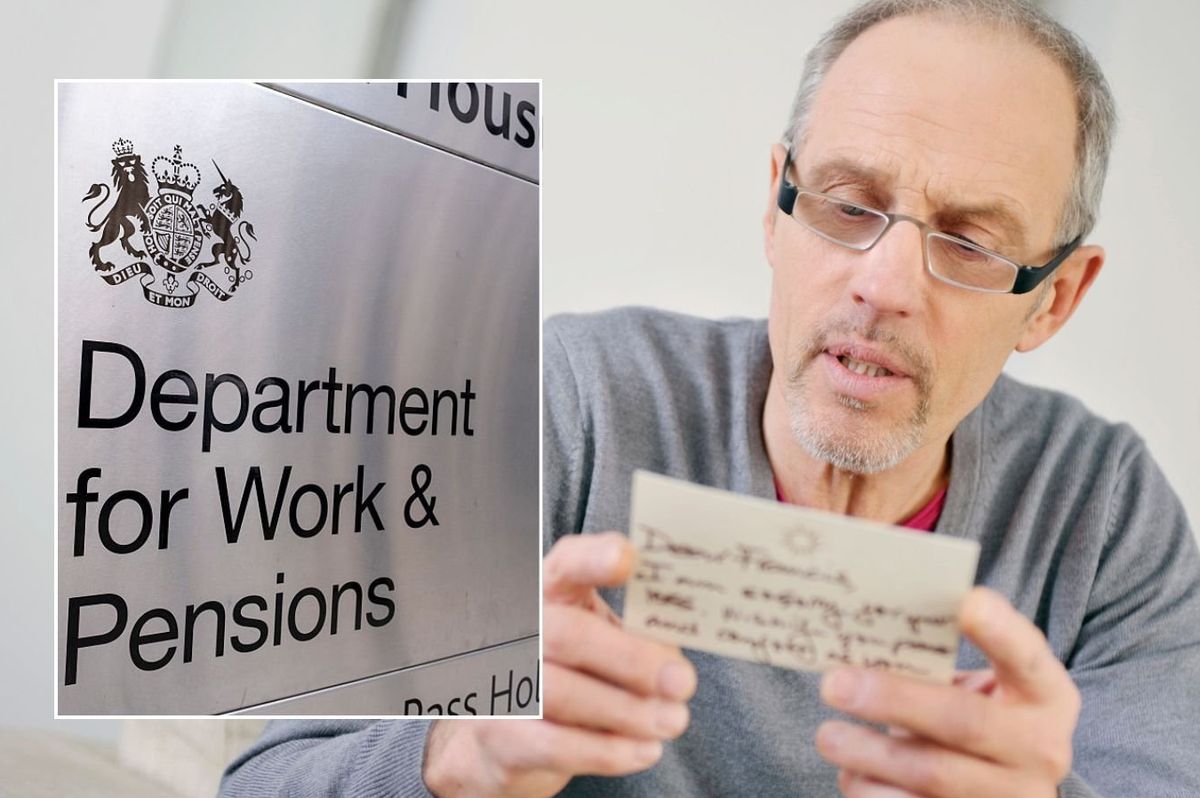 Man looking at letter and DWP sign