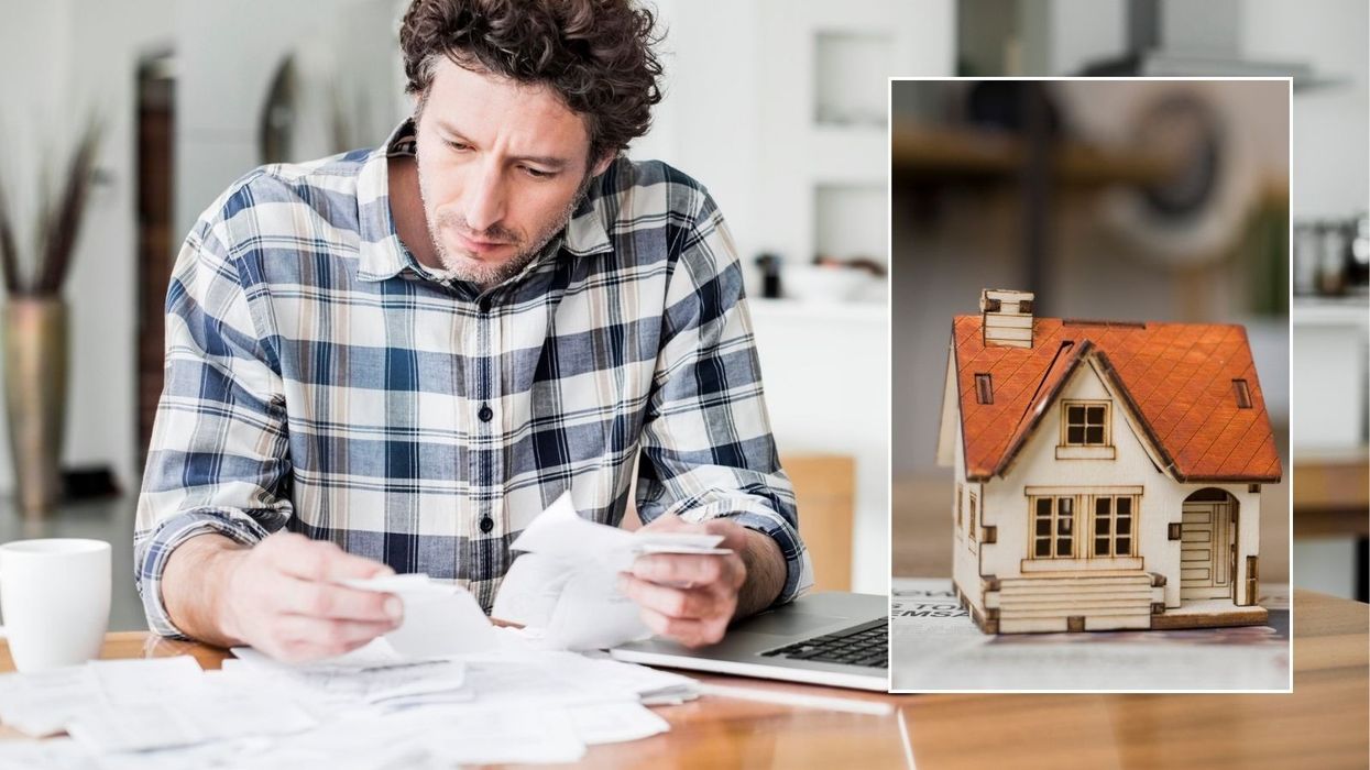 Man looking at letter and mini house