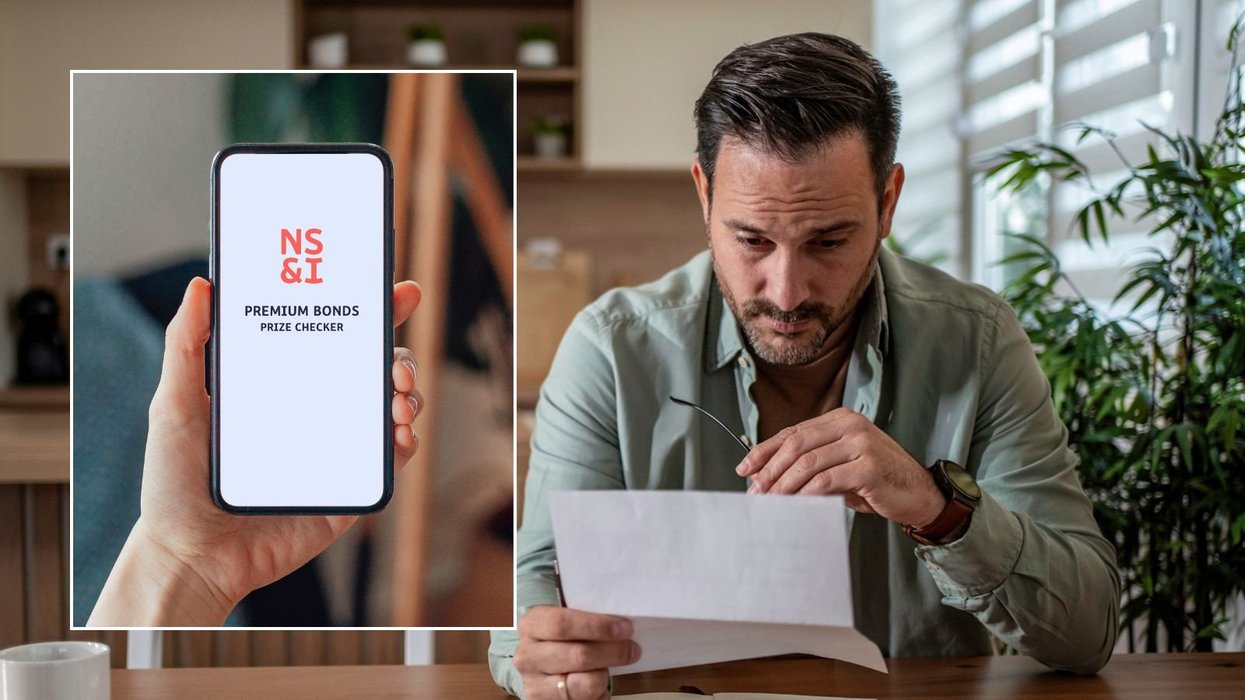 Man looking at letter and NS&I Premium Bond checker