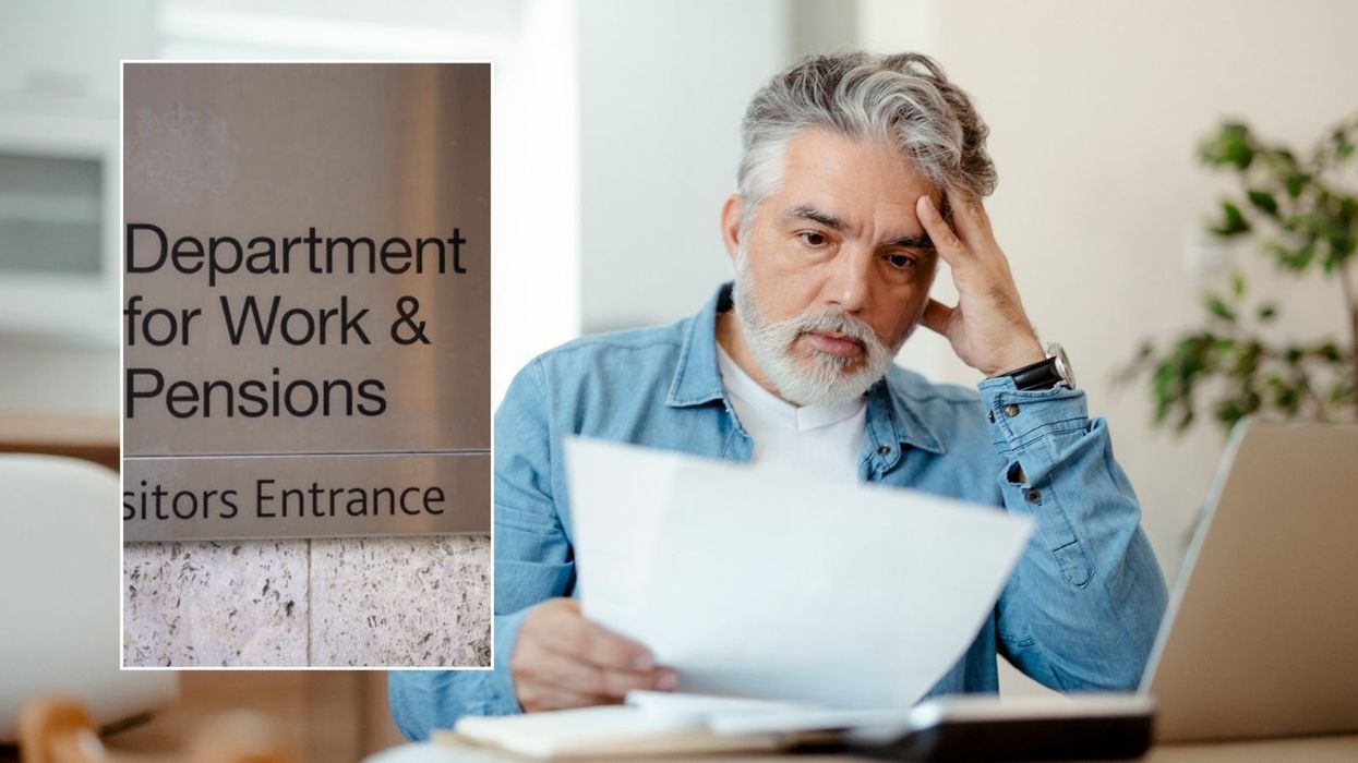 Man looking at paper and DWP sign