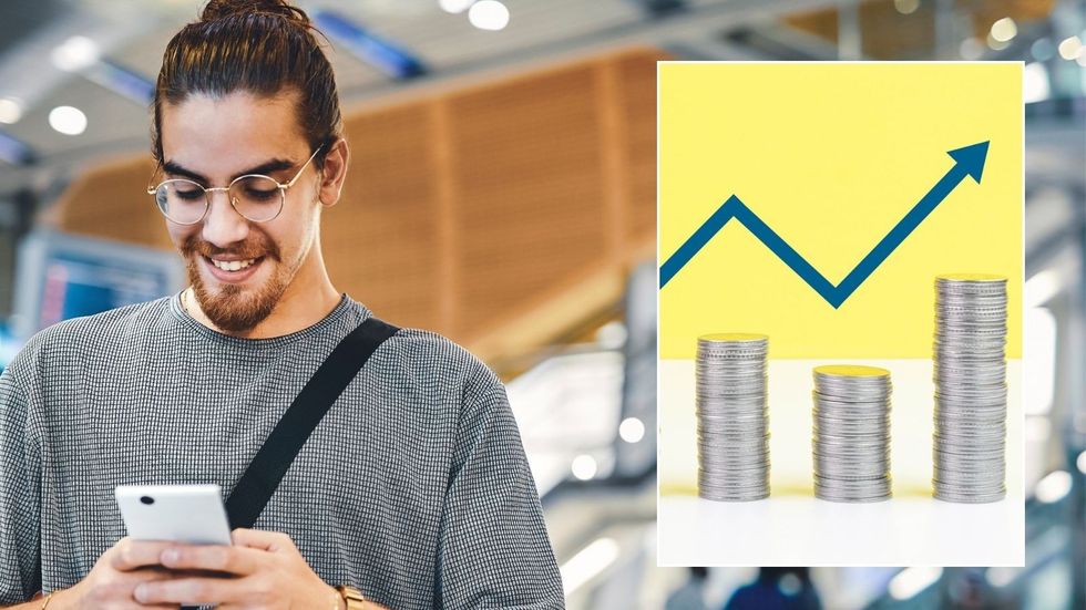 Man looking at phone with interest rate graph