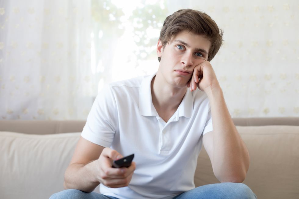 Man looking bored watching TV