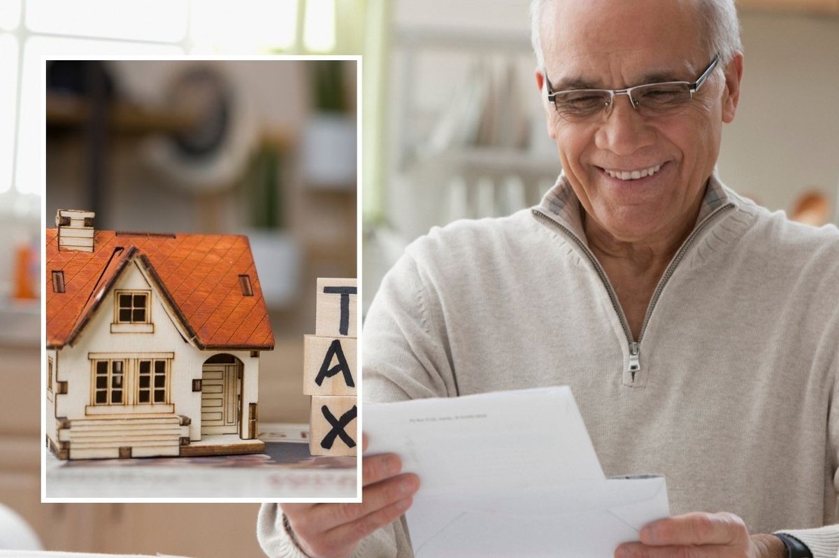 Man looking happy at financial statement and tax sign