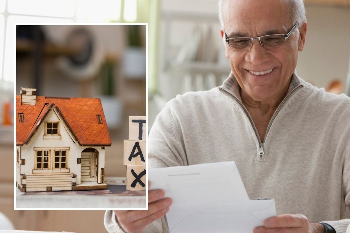 Man looking happy at financial statement and tax sign