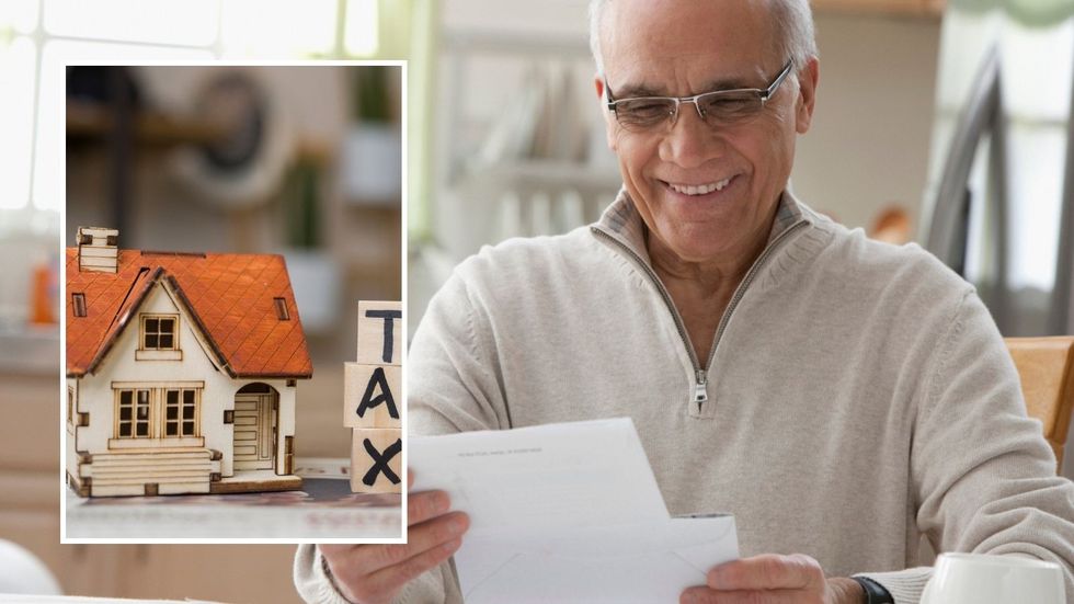 Man looking happy at financial statement and tax sign