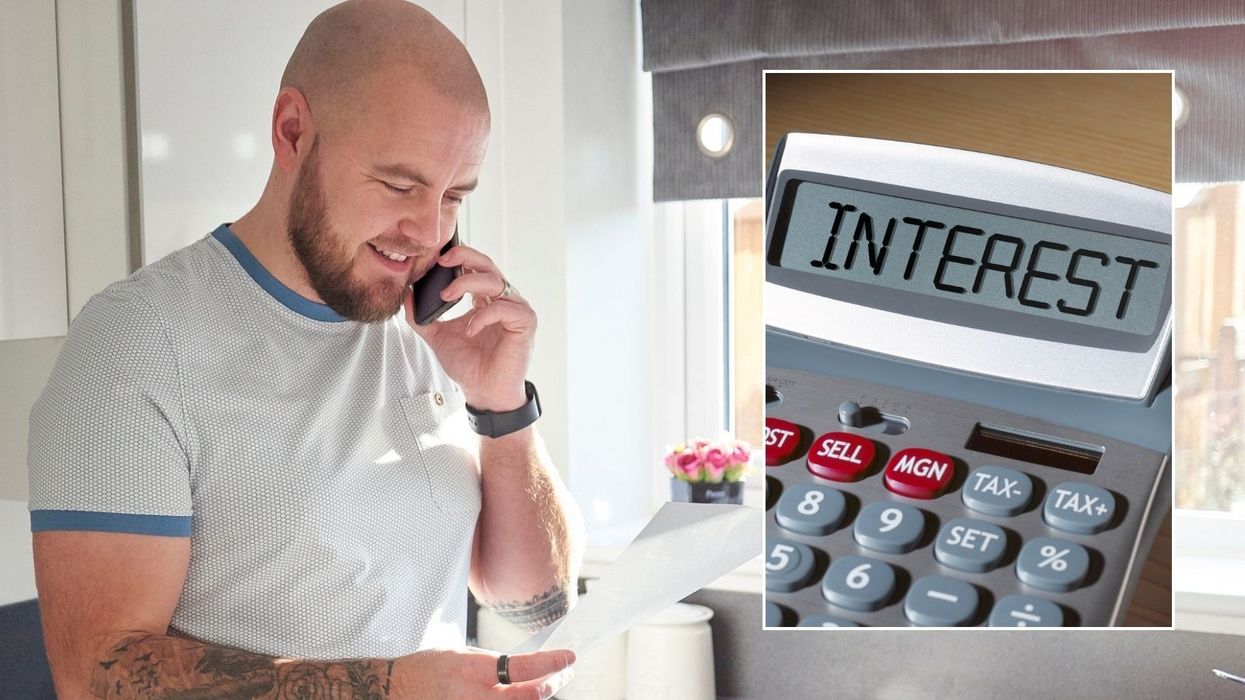 Man looking happy at letter and interest calculator