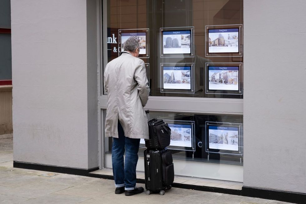 Man looking in estate agents