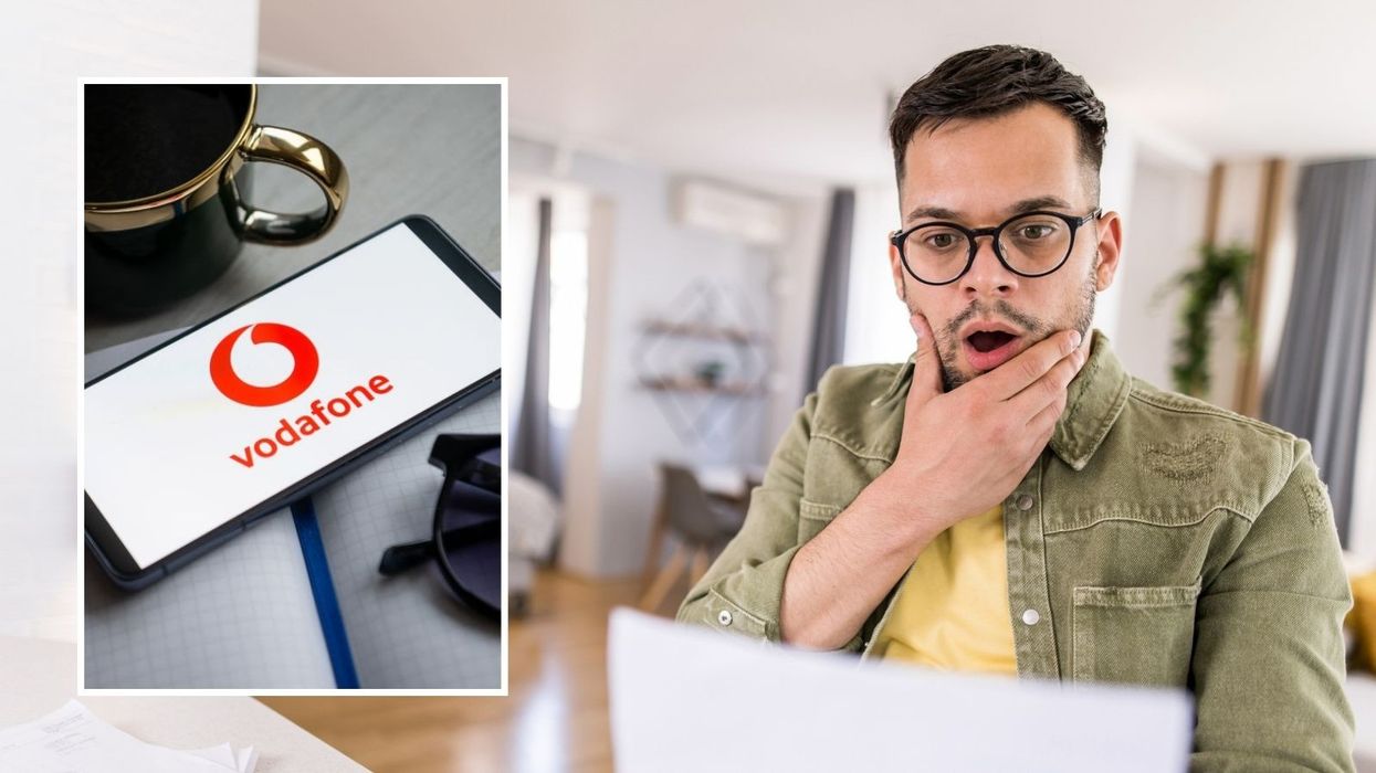 Man looking shocked at bill and Vodafone logo