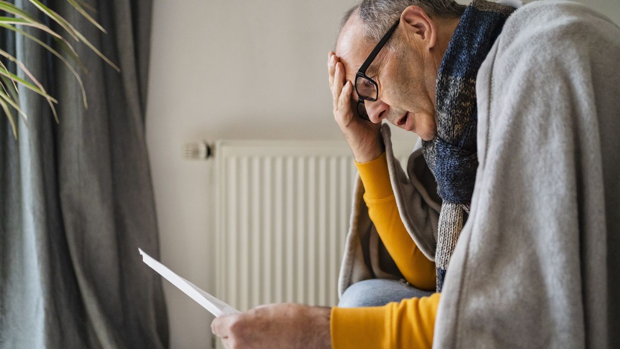 Man looking shocked at his energy bills