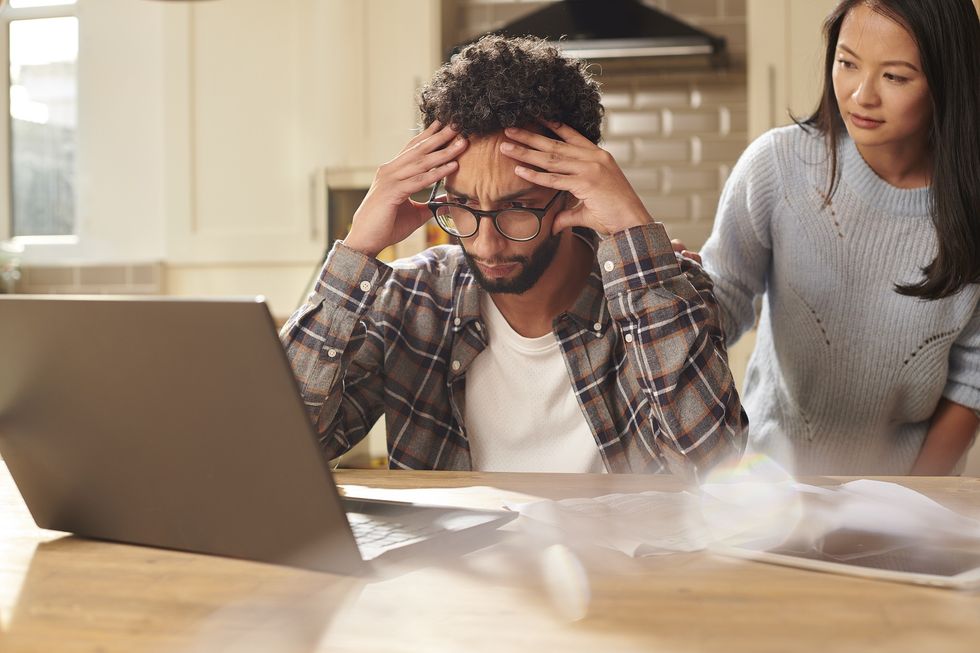 Man looking stressed at laptop