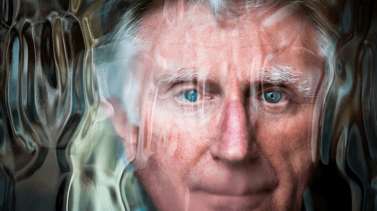 Man looking through a glass window