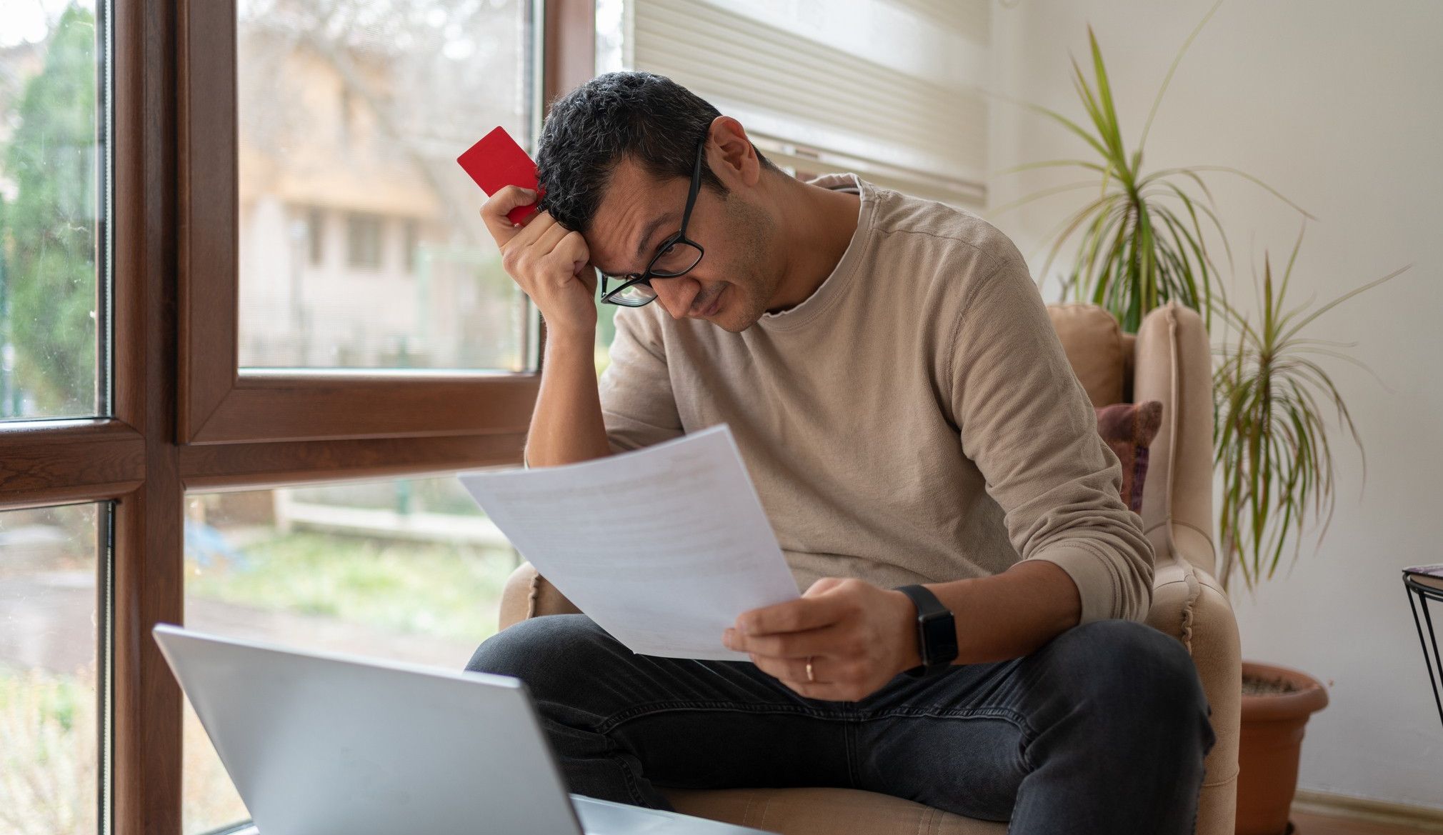 Man looking worried at bills
