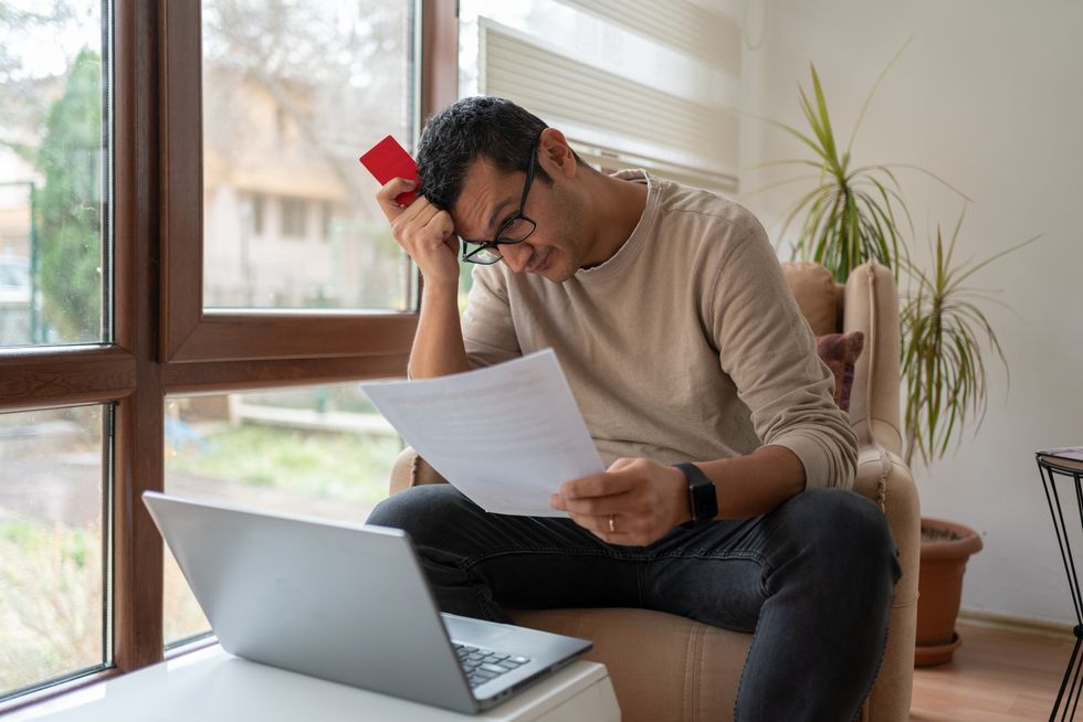 Man looking worried at bills